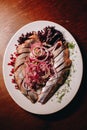 Sliced Ã¢â¬â¹Ã¢â¬â¹herring with onions on a white plate